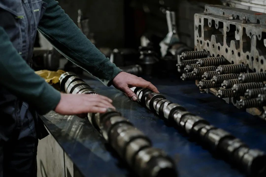 Technician inspecting machined parts